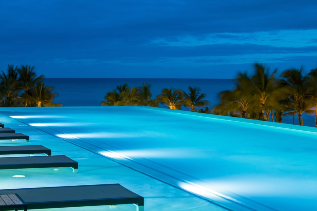 alohilani resort hotel infinity pool over looking the ocean at night